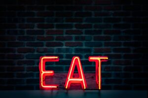 red eat neon sign turned on
